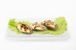Mussels on a plate with lettuce and lemon