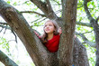 Photo: children kid girl playing climbing to a tree in a park children kid girl playing climbing to a tree in a park
