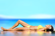 Sunbathing woman relaxing under sun in luxury