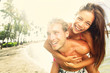 Happy young joyful couple beach fun laughing Happy young joyful couple beach fun laughing