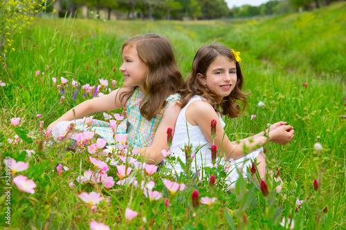 Photo: children friends girls on spring poppy flowers meadow children friends girls on spring poppy flowers meadow