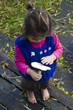 Child holds forest mushroom