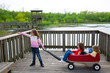 Photo: girls looking at park lake with outdoor dump cart girls looking at park lake with outdoor dump cart