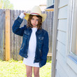 Little kid girl pretending to be a cowboy