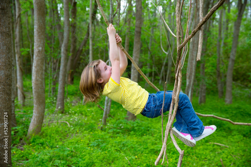 Photo: girls playing hanging in lianas at the jungle park girls playing hanging in lianas at the jungle park