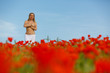 Nude girl in a poppy field