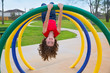 children kid girl upside down on a park ring