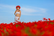 girl in a white dress in the poppy field