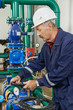 heating engineer repairman in boiler room