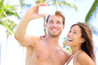 Vacation couple taking pictures with camera phone