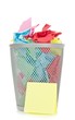 A waste paper bin with coloured paper on a white background