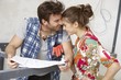 Happy couple with floor plan