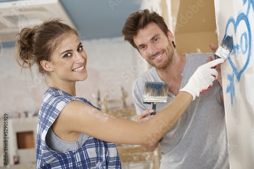 Photo: Romantic couple renovating house Romantic couple renovating house