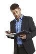 Young businessman looking at organizer