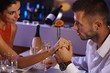Foto: Romantic couple at dinner table Romantic couple at dinner table
