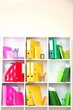 White office shelves with different stationery, close up