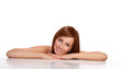 Portrait of a smiling young female lying down