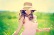 Beautiful happy woman in hat on summer meadow