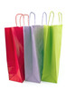 Foto: Three colorful paper shopping bags Three colorful paper shopping bags