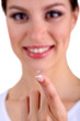 Young woman putting contact lens in her eye close up