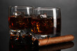 Brandy glasses with ice on grey background