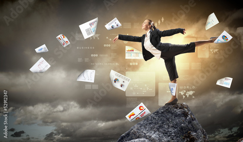 Photo: businesswoman standing atop of mountain businesswoman standing atop of mountain