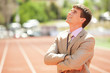 Photo: Businessman at athletic stadium and race track Businessman at athletic stadium and race track