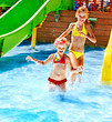 Children on water slide at aquapark.