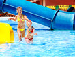 Children on water slide at aquapark.