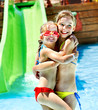 Children on water slide at aquapark.