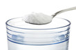 Spoon of baking soda over glass of water