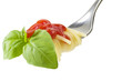 fork with spaghetti sauce and basil on white