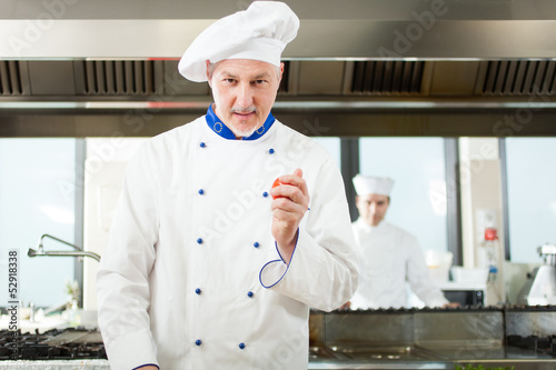 Photo: Chef cooking in his kitchen Chef cooking in his kitchen