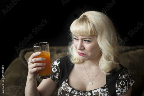 Photo: Beautiful Young Woman with Blond Hair Drinking Mango Juice Beautiful Young Woman with Blond Hair Drinking Mango Juice