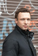 Portrait of young Caucasian man in black with graffiti