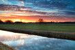 beautiful calm  sunset over river in farmland
