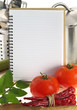 Blank recipe book and vegetables