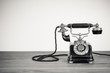 Vintage old telephone on wood table black and white photo
