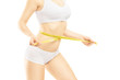 Attractive woman in white cotton underwear measuring her waist
