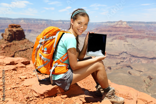 Photo: Tablet computer woman hiker hiking in Grand Canyon Tablet computer woman hiker hiking in Grand Canyon