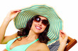 Woman wearing sunglasses and a hat.