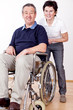 woman helps a wheelchair user in the office