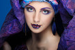 beautiful  girl in a head-dress from the coloured fabric
