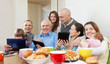 Happy family or friends with electronic devices