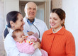   doctors talks to young mother of  baby