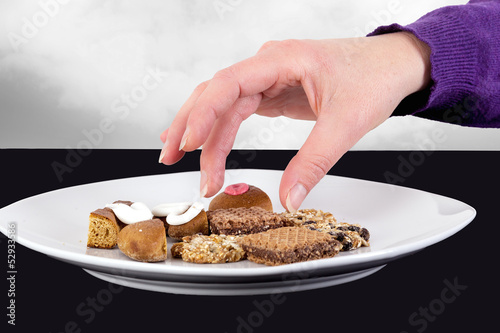 Photo: Hand reaching for cake plate Hand reaching for cake plate