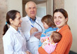  woman with two children talks to doctors