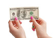 Woman’s hand holding 100 US dollar banknote, isolated on white