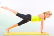 beautiful pilates instructor with yellow yoga mat