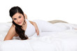 Photo: Cute brown-haired woman lying on a bed Cute brown-haired woman lying on a bed